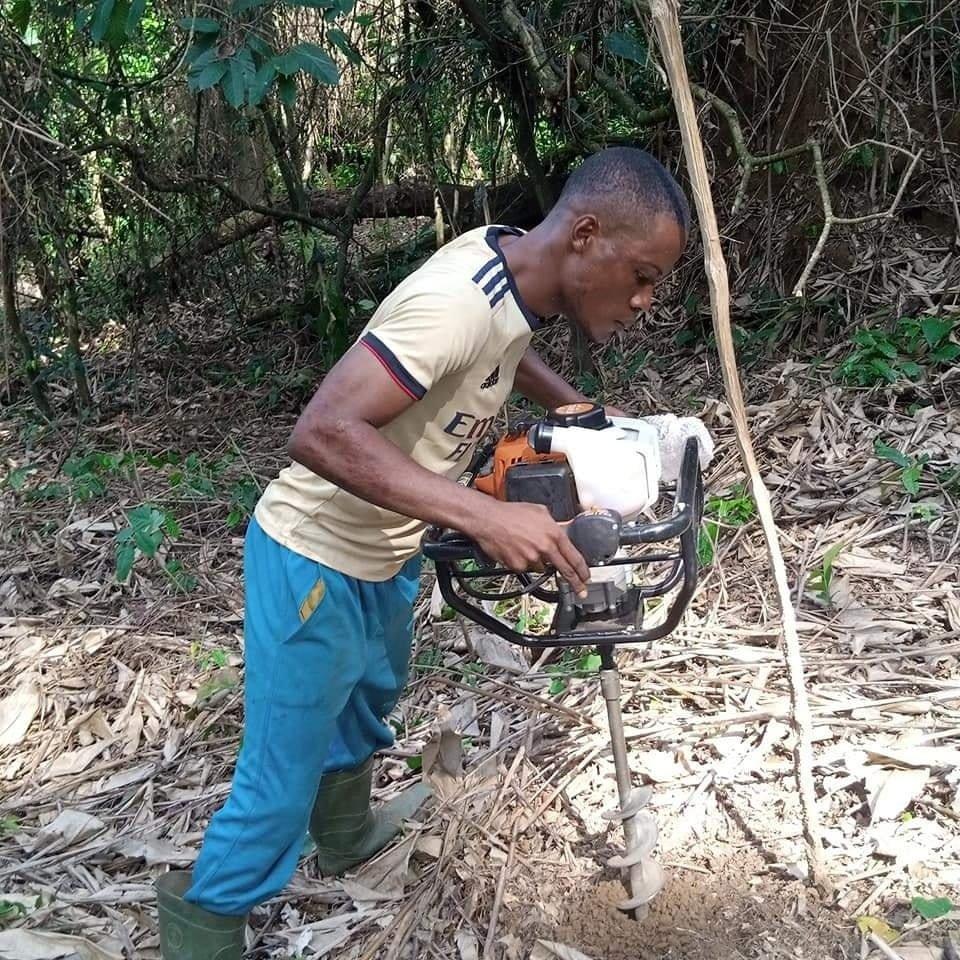 Preparing land for planting with an earth auger